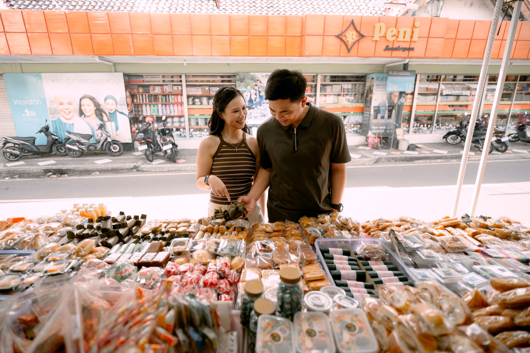 Angelia and Daniel choose food at a street market.