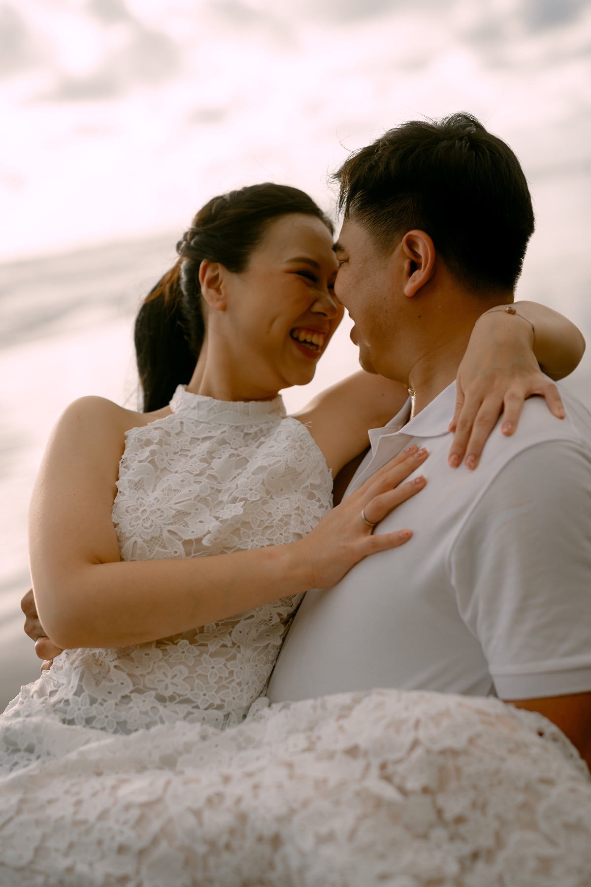 Angelia and Daniel smile together in a close embrace.